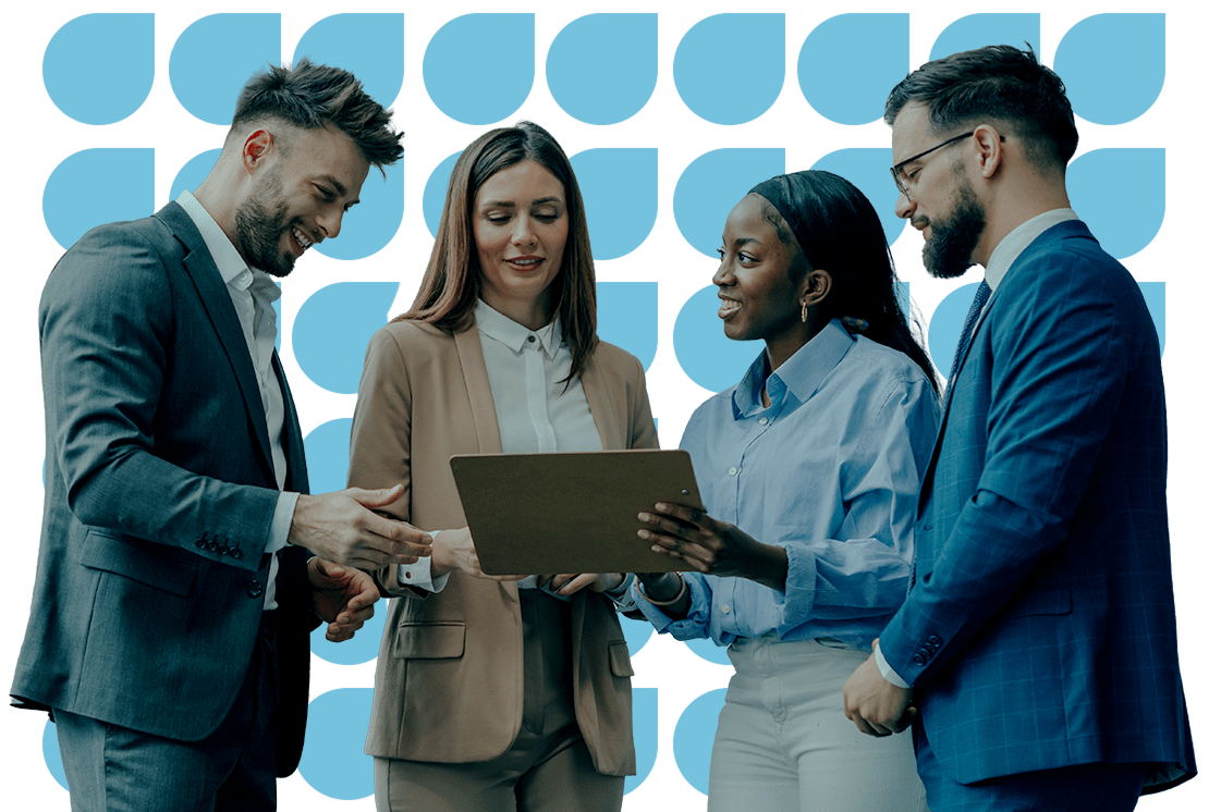 Group of people looking over a laptop screen together
