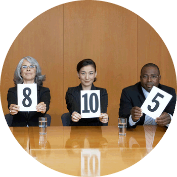 panel of three judges holding up score cards